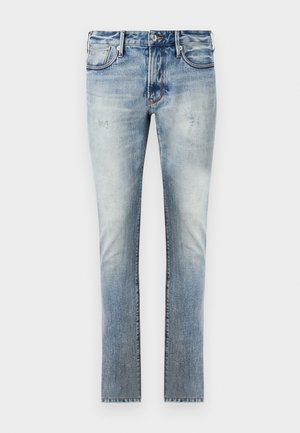 Lys blå denim jeans med en falmet finish, slim fit-design, fem lommer og kontrasterende sømmer.