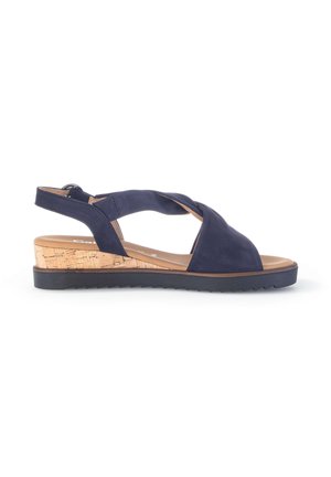 Navy blue wedge sandal with crisscross straps, cork platform sole, and black serrated rubber outsole.