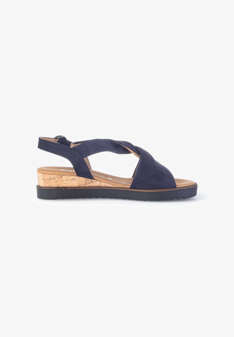 Navy blue wedge sandal with crisscross straps, cork platform sole, and black serrated rubber outsole.