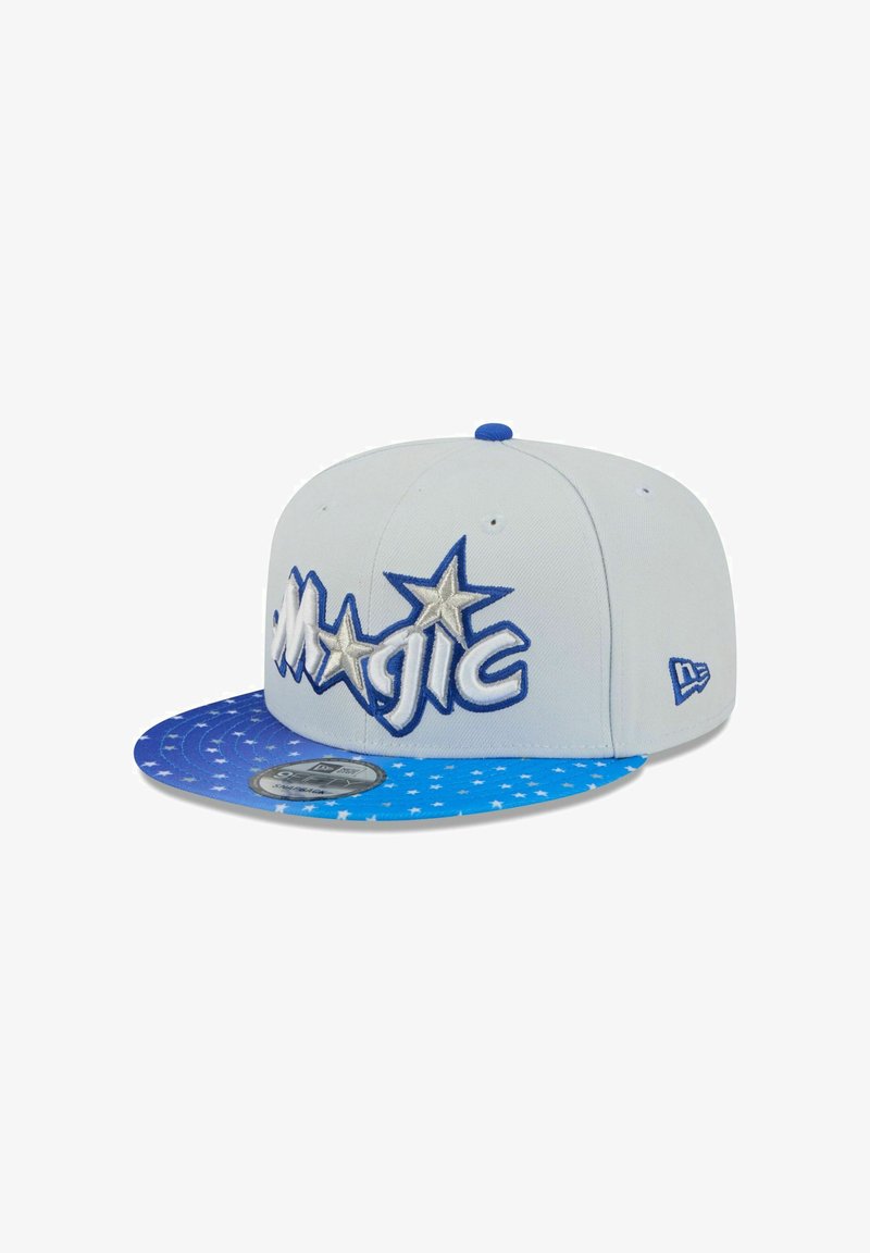 Blue and white snapback cap with embroidered "MAGIC" text and star accents. Features a blue, star-patterned visor and solid body.