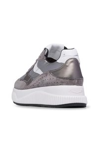 Sneaker grigio con una combinazione di pelle liscia e texture scamosciata, una suola bianca chunky e dettagli perforati sui lati.