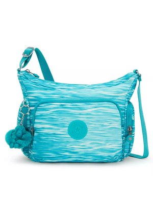 Turquoise shoulder bag with wavy patterns, made of durable fabric. Features a front zip pocket, keychain charm, and adjustable strap.