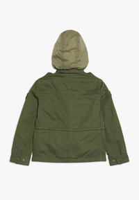 Olive green jacket with a removable light green hood, buttoned cuffs, and a drawstring waist. Textured fabric with a smooth finish.