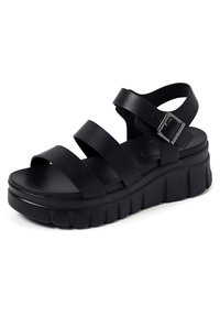 Sandali platform neri con tre larghe cinghie. Realizzati in materiale liscio, presentano una fibbia e una suola spessa e testurizzata per maggiore altezza.