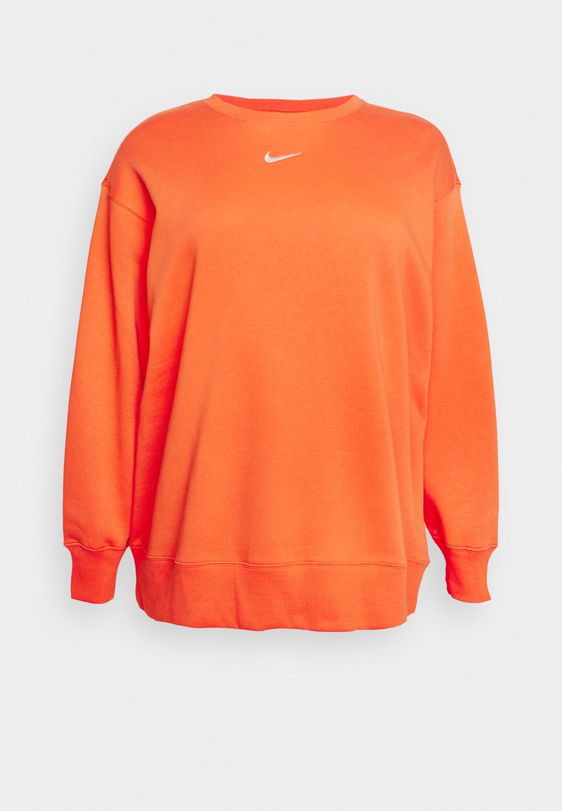 Sweat-shirt orange avec un col rond, coupe ample et poignets côtelés. Il arbore un petit logo blanc de Nike centré sur la poitrine. Texture lisse.