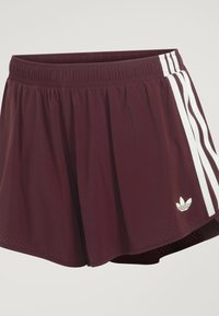 Mørkerøde træningsshorts med elastisk linning, hvide tre striber på siden og hvidt Adidas trefoil-logo nær kanten.