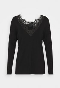 Pull noir à manches longues avec encolure en V, présentant une insertion superposée de dentelle noire au niveau de l'encolure.