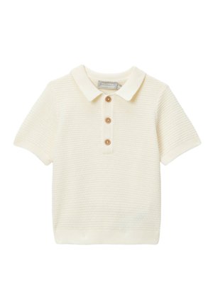 Polo en maille couleur crème à manches courtes avec col et ourlet côtelés, comportant trois boutons en bois sur le devant.
