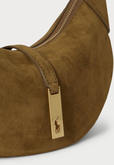 Καφέ σουέτ τσάντα χειρός με γωνία και χρυσό κλείσιμο φερμουάρ, διαθέτει ανάγλυφο έμβλημα polo παίκτη και λεπτομερή ραφή στη λωρίδα.