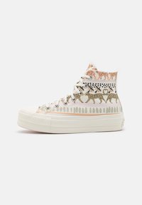 High-top sneakers in white canvas featuring animal print patterns in gold, pink, and black with rubber soles and eyelet lace closures.