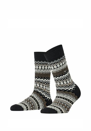Par de calcetines tipo crew negros con patrones geométricos y en zigzag en blanco, gris y marrón, exhibidos sobre un fondo blanco.