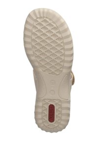 Tan sandaalzool met een gestructureerd rubberontwerp, met een rasterpatroon voor grip en een rood logo-label op de hiel. Maat gemarkeerd als 36.