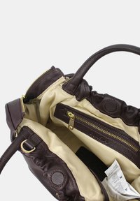 Borsa a tracolla in pelle marrone con interno crema, dotata di cerniere e tasche in tonalità oro, progettata con una parte superiore arricciata e manici robusti.