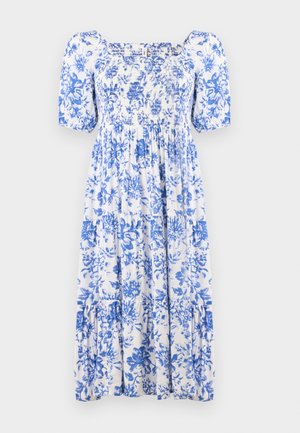 Balta ir mėlyna gėlių rašto suknelė, su smulkia raukiniu viršuje, trumpomis pūkuotomis rankovėmis ir pakopine apačia. Pagaminta iš lengvos medžiagos.