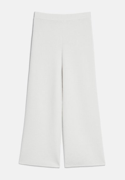 Pantalon blanc à jambes larges avec taille haute et sans attaches visibles, présenté à plat sur un fond clair.