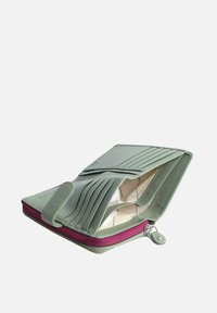Green leather wallet with zip closure, multiple card slots, and smooth texture. Interior features a beige lining and a contrasting pink zipper.