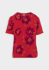 Rød kortærmet top med et blomstermønster i lilla og orange. Har en nøglehulåbning bagpå. Glat stof med en afslappet pasform.
