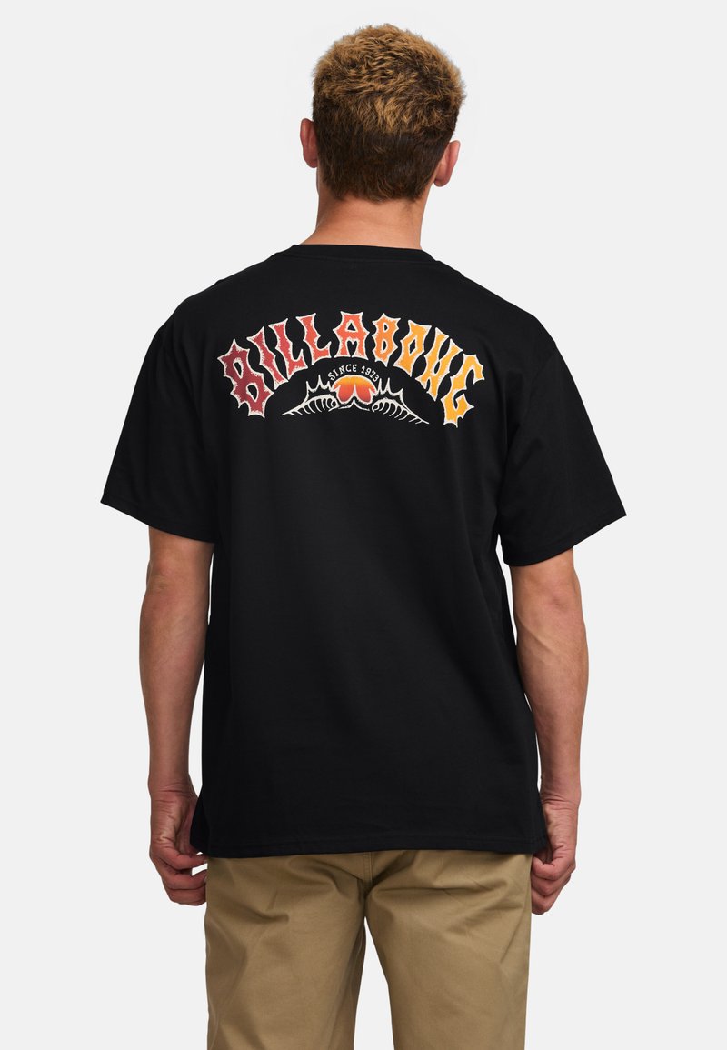 Black cotton t-shirt featuring colorful "BILLABONG" text and a heart design with wings on the back. Short sleeves, standard fit.