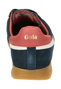 Blue suede shoe with a pink leather heel, white stripe, and gold logo. Gum rubber sole, low-top design, and soft interior lining.