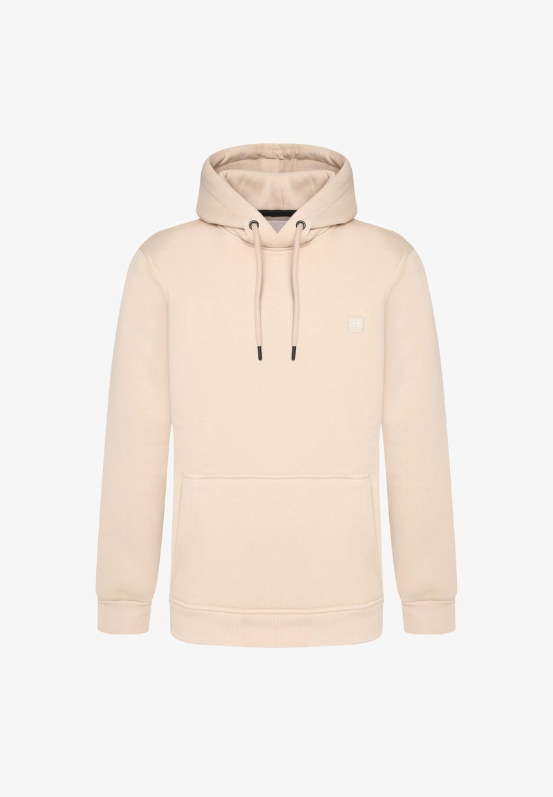Un hoodie de couleur crème en tissu doux, avec une poche frontale, des cordons de serrage et un petit logo sur la poitrine. Coupe normale.