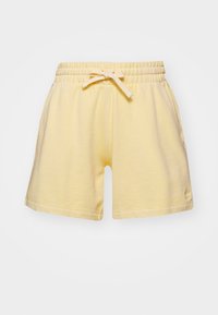 Ljusgula bomullsshorts med elastisk midja och knytband, med sidfickor och liten logotyp på vänster fåll.