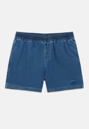 Sinised teksapüksid elastse vöökohaga, millel on Nike logo tumesinises ning sile ja tekstuuriga viimistlus.