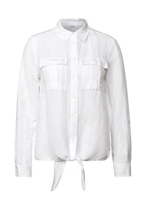 Camicia bianca in lino con colletto, due tasche sul petto e vita annodata. Maniche lunghe con polsini abbottonati.