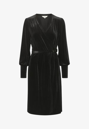 Rochie din catifea neagră, cu mâneci lungi tip puff, decolteu adânc în V și curea la talie. Textură netedă și tiv până la genunchi.