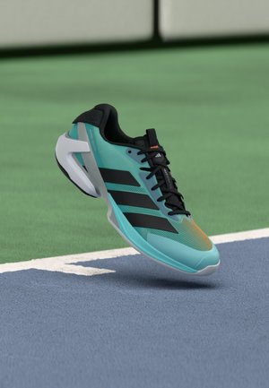 Turquoise athletic shoe with black accents, mesh upper, and a white sole. Features three black stripes and a lightweight design.