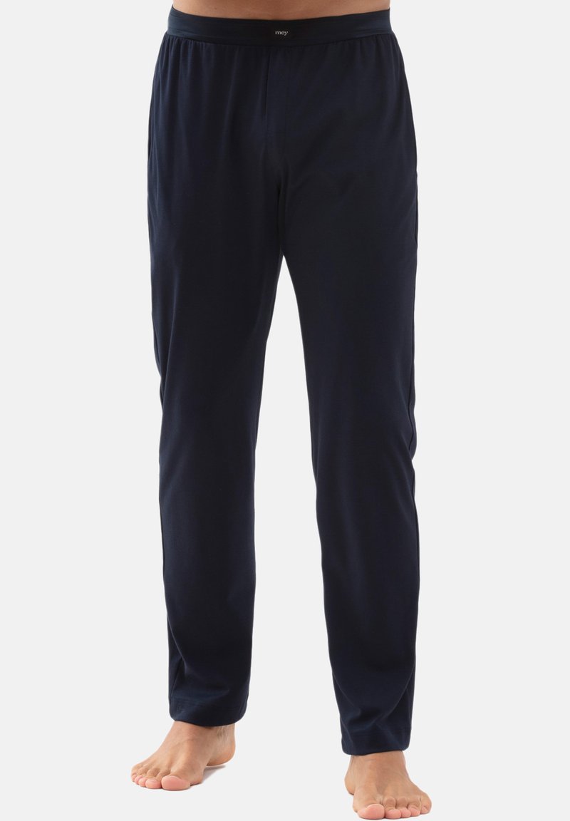 Donkerblauwe broek van zachte stof, met een elastische tailleband en rechte snit. Minimalistisch ontwerp, zonder zichtbare patronen of accenten.
