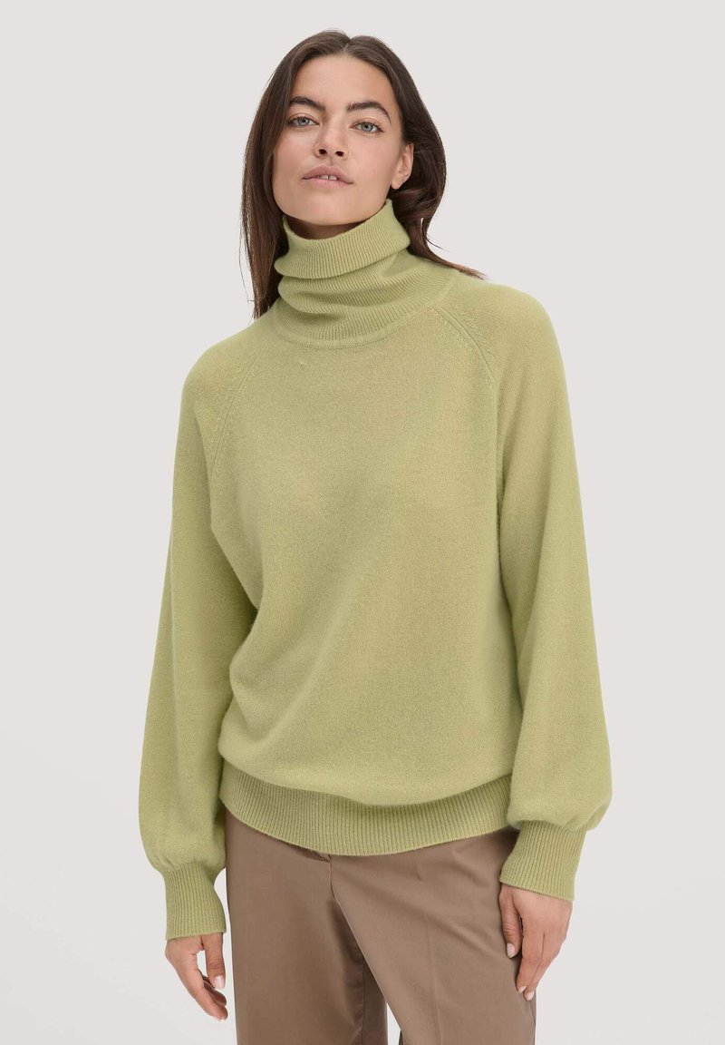 Hellgrüner Rollkragenpullover aus weichem Material, mit lockerer Passform, Raglanärmeln und gerippten Bündchen und Saum.
