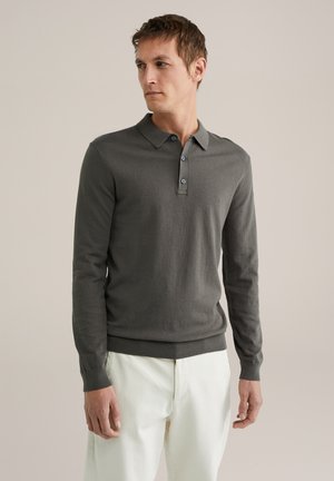 Dark grey long-sleeve polo shirt made of a smooth fabric, featuring a buttoned collar and ribbed cuffs, worn with light-colored pants.