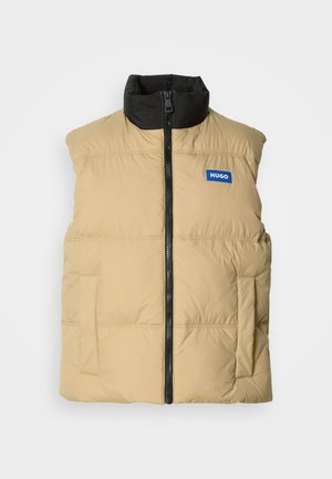 Beige padded vest with a black high collar, front zipper, and two side pockets. Features a blue "HUGO" logo on the chest.