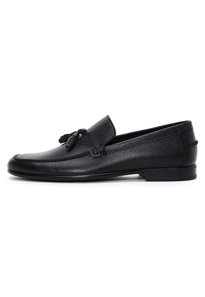 Black leather loafers featuring a textured finish, rounded toe, and decorative tassel detail on the vamp; low-profile rubber sole.