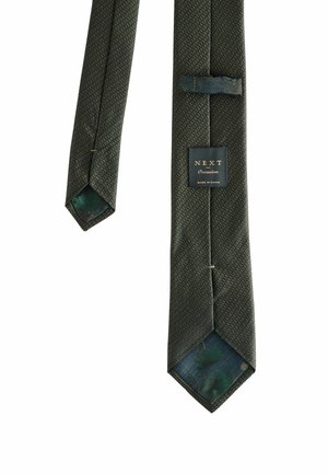 Dark green textured necktie with a subtle cross pattern, showing label "NEXT Occasion" and a patterned inner lining.