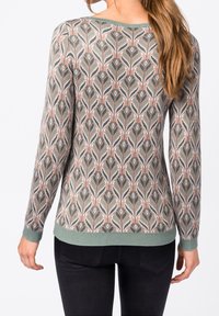 Sweter dziergany w kolorach zielonym, beżowym i białym z motywem liści. Posiada okrągły dekolt i prążkowane mankiety. Gładka faktura.