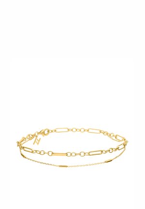 Gold chain bracelet featuring elongated links, a double-layer design, and a small charm accent. Smooth texture with a polished finish.