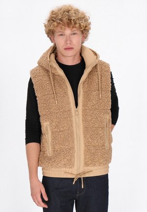 Tan fleece vest met een gestructureerd oppervlak, voorkant met rits, twee ritszakken en een trekkoord onderaan. Met capuchon en een gladde binnenvoering.
