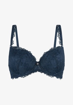 Navy blue lace bra with padded cups, floral pattern, scalloped edges, adjustable straps, and a central decorative hardware detail.