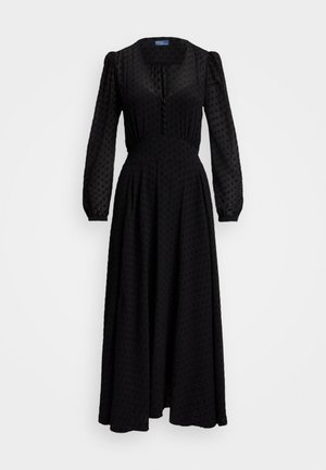 Black, long-sleeve dress featuring a deep V-neck, textured fabric with raised dots, fitted waist, and flowing skirt. Buttons along the front.