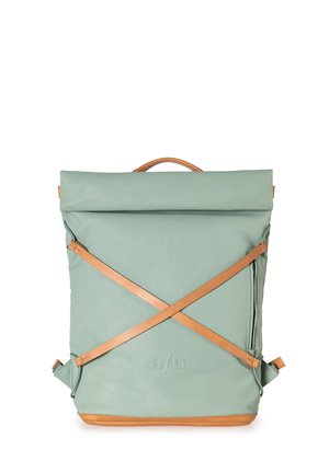 Backpack with a rolled top, made of light green synthetic material. Features tan leather straps crossed on the front and a top handle.