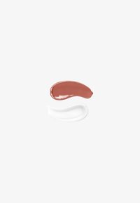 Two cosmetic cream smears on a white background: one brown glossy and one white transparent.