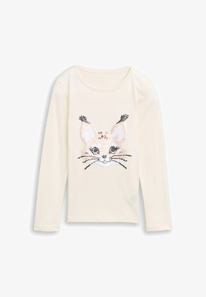 Crème lange mouwen shirt met een paillettenkat gezicht ontwerp in beige, zilver en zwart. Zacht materiaal met een ronde halslijn.