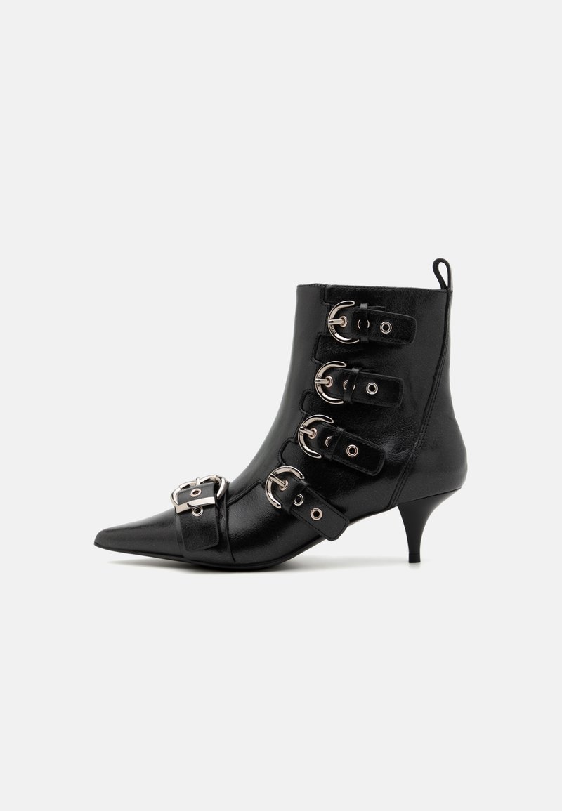 Black leather ankle boot with pointed toe, featuring five straps with silver buckles, a kitten heel, and a loop at the back for easy wear.