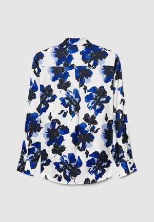 Blusa floreale bianca con motivi floreali blu e neri. Maniche lunghe, polsini con bottoni e piega posteriore. Tessuto liscio e leggero.