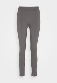 Grå leggings tillverkade av ett elastiskt tyg med en glatt yta. Har hög midja och vertikala sömdetaljer fram och bak.