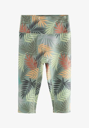 Grüne Capri-Leggings mit tropischem Blattmuster in Orange-, Schwarz- und Grüntönen. Hergestellt aus dehnbarem Material mit glatter Textur.