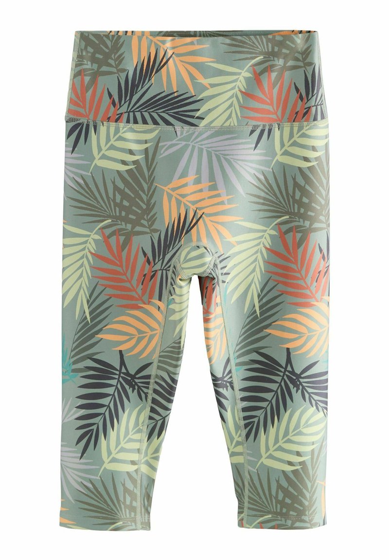 Leggings courts sur une base verte avec un motif de feuilles tropicales multicolores dans des nuances d'orange, de noir et de vert. Présentent une taille haute.