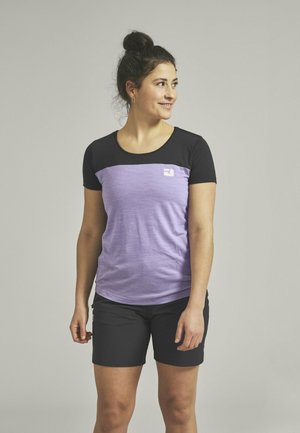 Short-sleeve top with a black upper and light purple lower section. Made of soft fabric, featuring a small logo on the chest. Worn with black shorts.