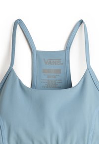 Lichtblauwe stretch zwemkleding met dunne bandjes, met een gladde textuur en het Vans-logo op de achterkant. Verzorgingsinstructies binnenin gedrukt.